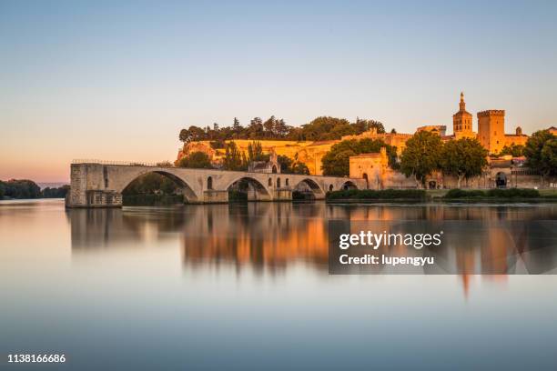 pont saint-benezet on rhone river and avignon cathedral at sunset,avignon - ponte saint benezet imagens e fotografias de stock