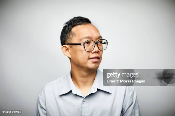 professional looking away on white background - chinese person stockfoto's en -beelden