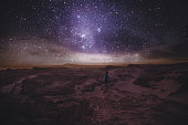 Woman looking at star sky at canyon in Atacama Desert