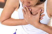 Woman's hand on chest suffering on chest pain. Female suffer from heart attack,Lung Problems,Myocarditis, heart burn,Pneumonia or lung abscess, pulmonary embolism day