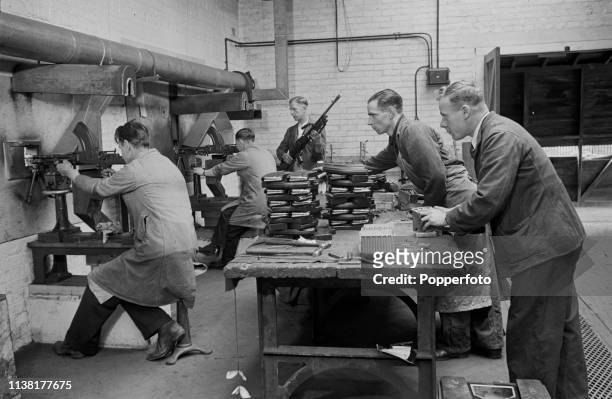 View of employees testing brand new recently manufactured Bren light machine guns on a firing range at the Royal Small Arms Factory in Enfield, north...