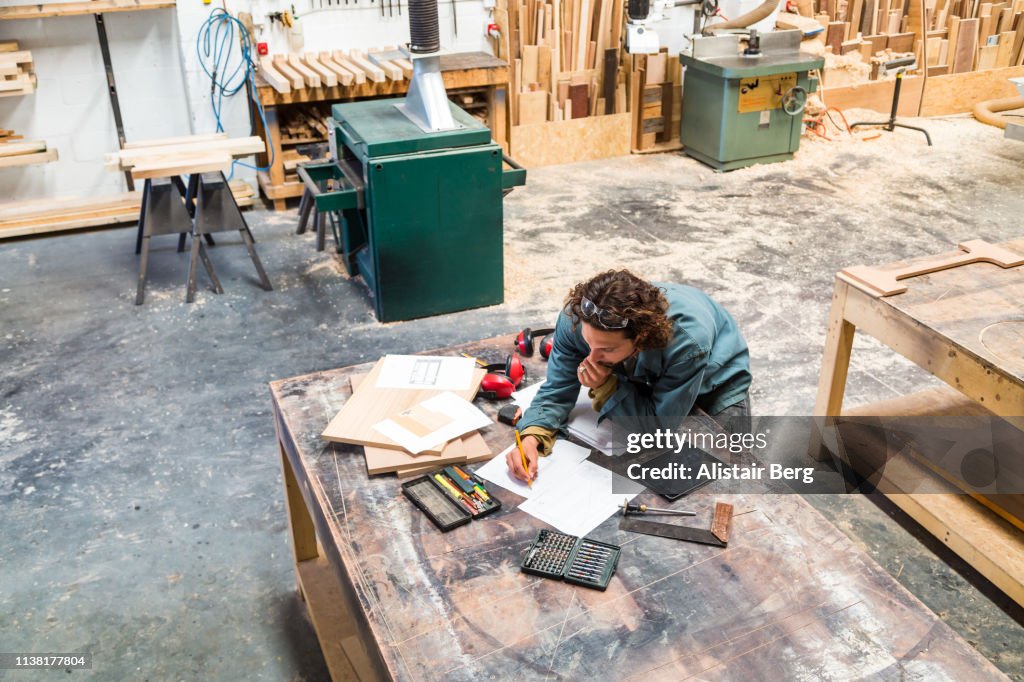 Designer working at a bench in a furniture factory