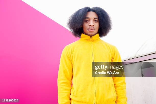 portrait of young man in yellow tracksuit - tracksuit fotografías e imágenes de stock