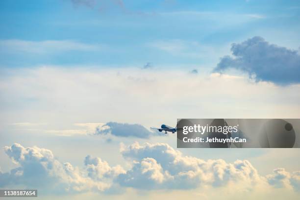 airplane against cloudy sky - air cargo stock pictures, royalty-free photos & images