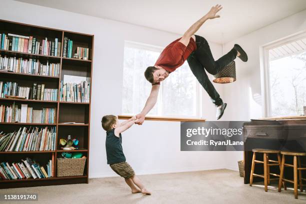 strong child throwing parent in the air - tantrum stock pictures, royalty-free photos & images