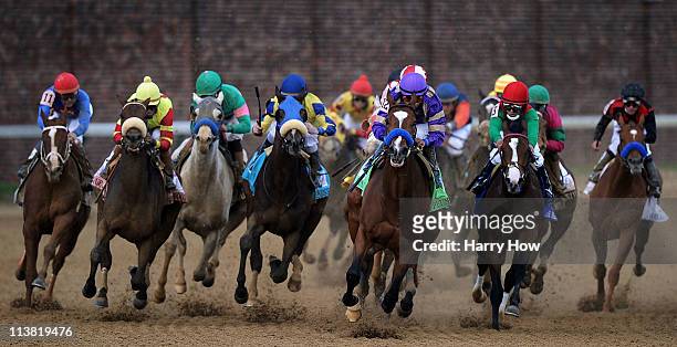 Jockey Martin Garcia, riding Plum Pretty leads the field around turn four on their way to winning the 137th Kentucky Oaks at Churchill Downs on May...