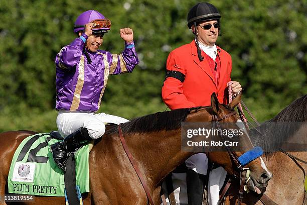 Jockey Martin Garcia, riding Plum Pretty, celebrates in the winners circle after they won the 137th Kentucky Oaks at Churchill Downs on May 6, 2011...