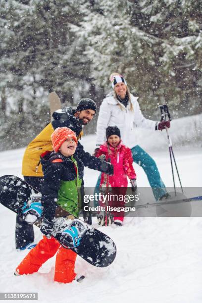 family at a ski resort - family skiing stock pictures, royalty-free photos & images