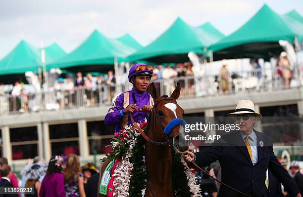 Jockey Martin Garcia rides atop fillie Plum Pretty after winning the 137th running of the Kentucky Oaks on the eve of the Kentucky Derby at Churchill...