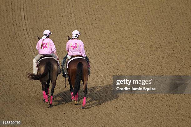 Outriders are seen on the track wearing pink jackets in support of breast cancer awareness during the 137th Kentucky Oaks at Churchill Downs on May...