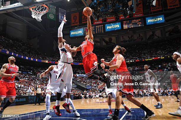 Derrick Rose of the Chicago Bulls shoots against Josh Smith of the Atlanta Hawks in Game Three of the Eastern Conference Semifinals in the 2011 NBA...