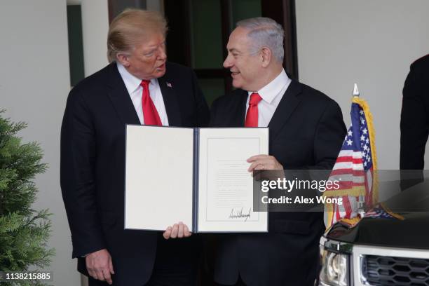 President Donald Trump and Prime Minister of Israel Benjamin Netanyahu show members of the media the proclamation Trump signed on recognizing...