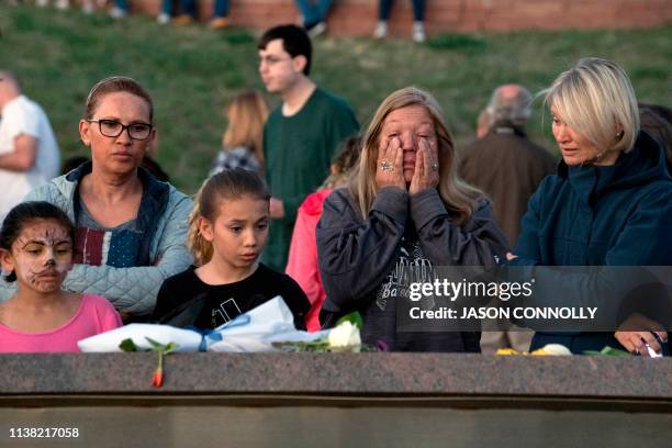 People gather to honor and remember loved ones at the Columbine Memorial at Clement Park in Littleton, Colorado, during a community vigil for the...