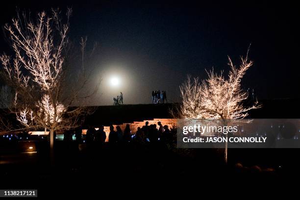 People gather to honor and remember loved ones at the Columbine Memorial at Clement Park in Littleton, Colorado, during a community vigil for the...