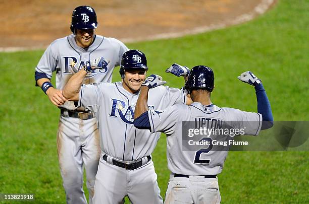 Johnny Damon of the Tampa Bay Rays celebrates with Ben Zobrist and B.J. Upton after hitting a home run in the ninth inning against the Baltimore...