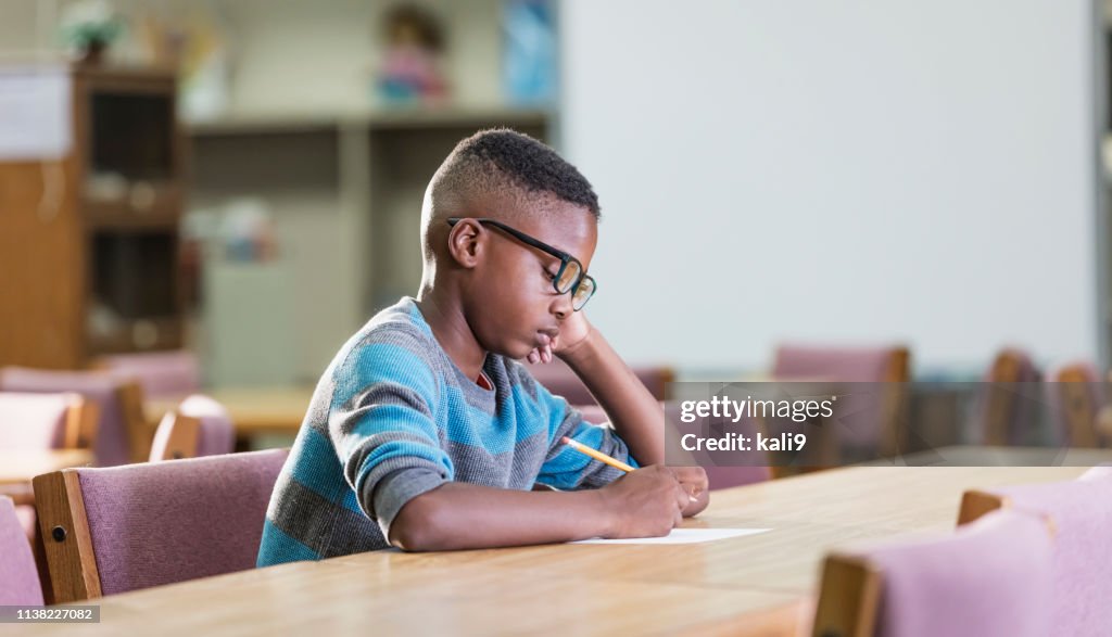 African-American boy in elementary school, writing