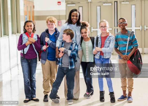 teacher with elementary students and down syndrome boy - special education stock pictures, royalty-free photos & images
