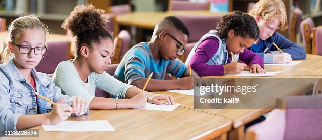 Elementary school students taking a test Elementary school students taking a test