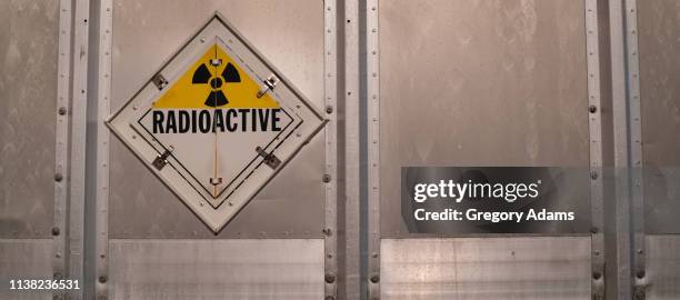 radioactive warning sign on the back of a truck - straling stockfoto's en -beelden