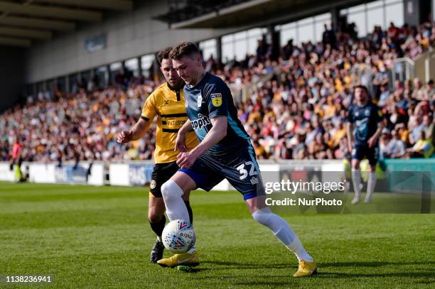 19th April Bury forward Caolan Lavery and Newport County midfielder Robbie Willmott during the Sky Bet League 2 match between Newport County and Bury...