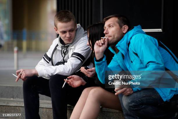 Young people smoke cigarettes while listening to the debate between the presidential candidates in Kyiv, Ukraine on April 19, 2019. On Sunday...