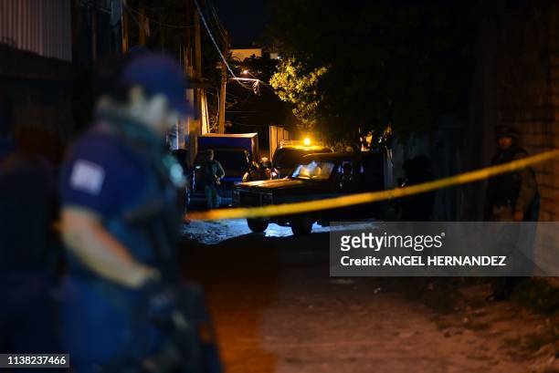 Members of the Minatitlan municipal police stand guard outside the place where 13 people were killed in a shooting, in Minatitlan, Veracruz State,...