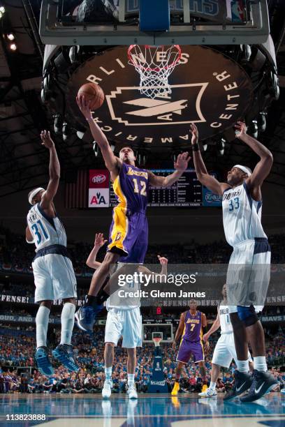 Shannon Brown of the Los Angeles Lakers shoots against Jason Terry and Brendan Haywood of the Dallas Mavericks during Game Three of the Western...