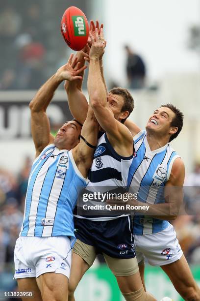 Cameron Mooney of the Cats marks over the top of Michael Firrito of the Kangaroos during the round seven AFL match between the Geelong Cats and the...