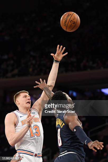 Henry Ellenson of the New York Knicks attempts a basket against Jarred Vanderbilt of the Denver Nuggets during the second half of the game at Madison...
