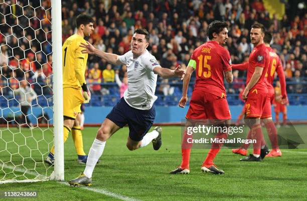 Michael Keane of England celebrates as he scores his team's first goal during the 2020 UEFA European Championships Group A qualifying match between...