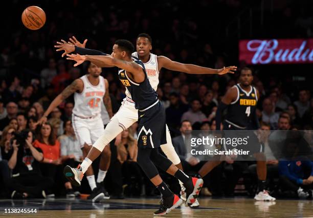 Frank Ntilikina of the New York Knicks guards Monte Morris of the Denver Nuggets during the second half of the game at Madison Square Garden on March...