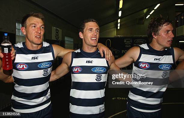 Darren Milburn, Joel Selwood and Mitch Duncan of the Cats sing the song in the rooms after winning the round seven AFL match between the Geelong Cats...