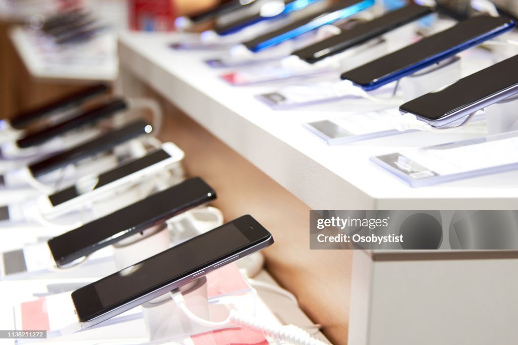 Smartphone's on the counter of a electronics store