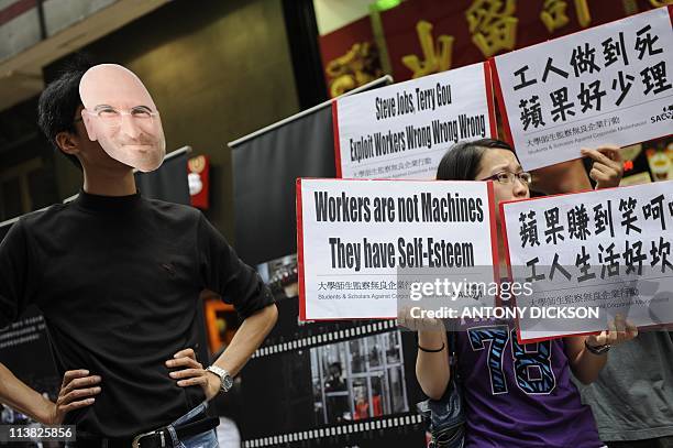 Participant wearing a mask of Apple CEO Steve Jobs takes part in a protest against Taiwanese technology giant Foxconn, which manufactures Apple...