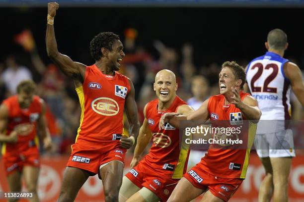 Liam Patrick, Gary Ablett and Daniel Harris of the Suns celebrate a goal by Liam Patrick during the round seven AFL match between the Gold Coast Suns...