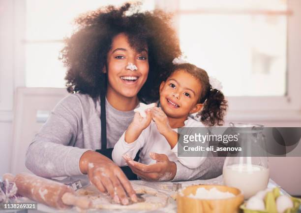 mother and daughter are baking together - massage funny stock pictures, royalty-free photos & images