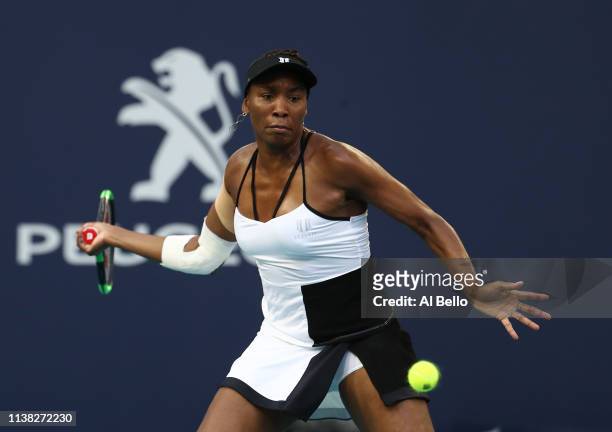 Venus Williams plays a point against Simona Halep of Romania during day 8 of the Miami Open presented by Itau at Hard Rock Stadium on March 25, 2019...