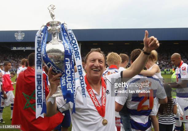 Manager Neil Warnock celebrates with the trophy after winning the npower Championship match between Queens Park Rangers and Leeds United at Loftus...