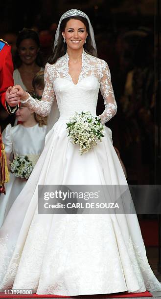 Kate, Duchess of Cambridge, comes out of Westminster Abbey, with her husband Britain's Prince William following their wedding ceremony, in central...
