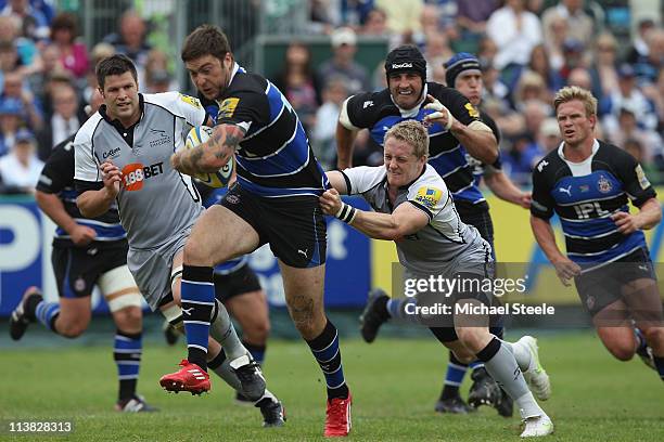 Matt Banahan of Bath breaks a tackle during the Aviva Premiership match between Bath and Newcastle Falcons at the Recreation Ground on May 7, 2011 in...
