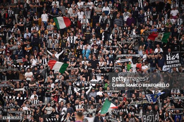 Juventus fans cheer during the Italian Serie A football match Juventus vs Fiorentina on April 20, 2019 at the Juventus stadium in Turin.