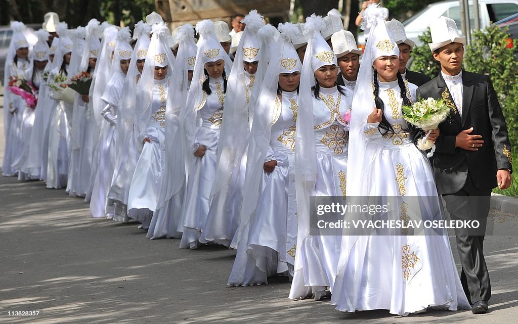 A group of Kyrgyz couples take part in a