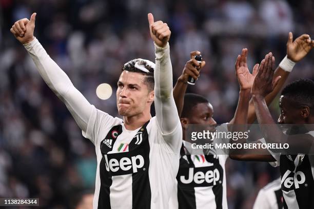 Juventus' Portuguese forward Cristiano Ronaldo acknowledges fans and celebrates after Juventus secured its 8th consecutive Italian 2018/19 "Scudetto"...