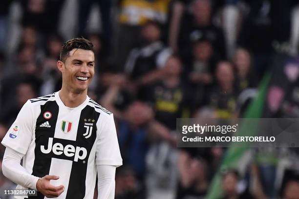 Juventus' Portuguese forward Cristiano Ronaldo celebrates after Juventus secured its 8th consecutive Italian 2018/19 "Scudetto" Serie A...