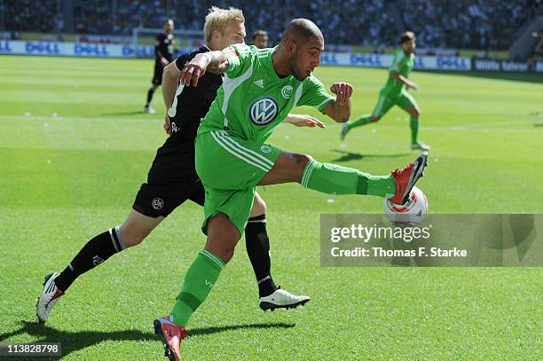 Leon Jessen of Kaiserslautern challenges Ashkan Dejagah of Wolfsburg during the Bundesliga match between VfL Wolfsburg and 1. FC Kaiserslautern at...