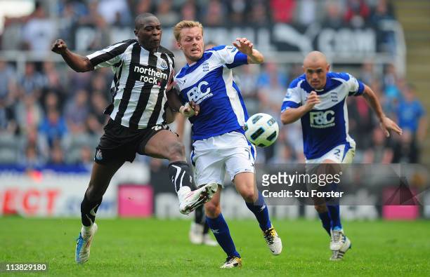 Birmingham player Sebastian Larsson battles with Shola Ameobi during the Barclays Premier League game between Newcastle United and Birmingham City at...