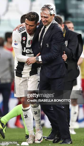 Juventus' Portuguese forward Cristiano Ronaldo and Juventus' Italian coach Massimiliano Allegri hold each other as they celebrate after Juventus...