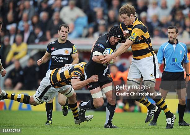 Richard Baxter of Exeter is tackled by Richard Birkett and Joe Launchbury of London Wasps during the AVIVA Premiership match bewteen Exeter Chiefs...