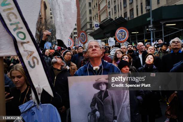 Holding flowers, pictures and traditional dresses, people attend the 108th anniversary ceremony for the victims of the Triangle Shirtwaist Factory...