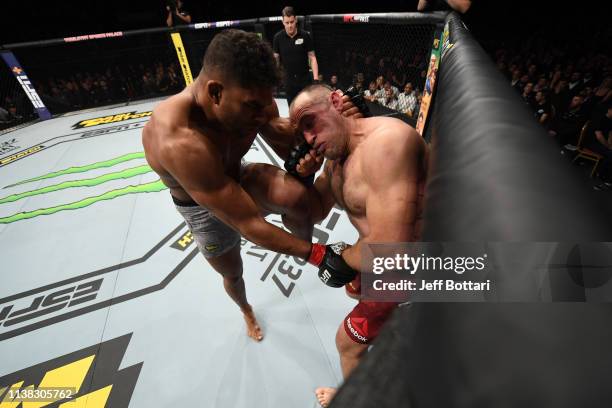 Alistair Overeem of The Netherlands knees Aleksei Oleinik of Russia in their heavyweight bout during the UFC Fight Night event at Yubileyny Sports...